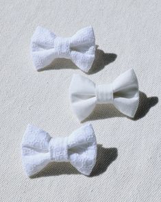 Perfect for any occasion (especially proper ones), the Take a Bow White Eyelet Bow Tie is an accessory that simply steals the show. Elevate your pup's collar instantly with this soft, cotton weave bow, complete with easy-to-attach velcro fasteners on the back. Lined perfectly to maintain its adorable shape, this sweet addition takes any collar from casual to classy (or dog park to runway). - Soft cotton weave- Convenient + easy velcro fasteners- Sized for a 1" collar (velcro can be trimmed)- Hand wash, air dry flat- 3.5" x 2.25"- Made in the US Classic White Bow With Ribbon, Adjustable White Bow Tie With Decorative Bow, White Adjustable Bow With Butterfly Knot, Classic White Bow With Butterfly Knot, Adjustable White Satin Bow Tie, Adjustable White Satin Bow, White Adjustable Bow Tie Back, Adjustable White Bow Tie Back, Adjustable Detachable White Bow