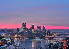 a city skyline at night with the lights on