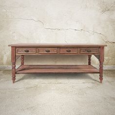 a wooden table with three drawers on one side and two shelves on the other end