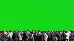 a large group of people standing in front of a green screen