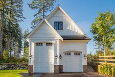 a large white house with two garages