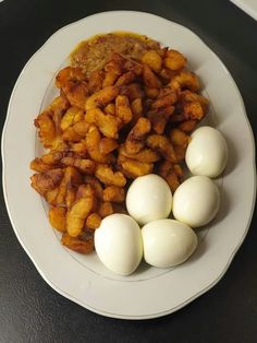 some eggs are sitting on a white plate