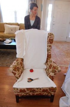 a woman sitting in a chair with scissors on it