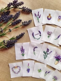 lavender flowers are arranged on napkins next to each other, which have been embroidered onto them