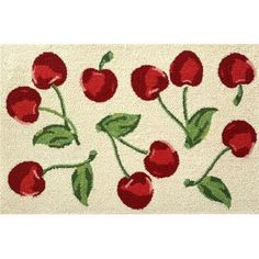 a white rug with red cherries on it