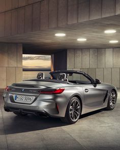 the new bmw z4 roadster convertible is shown in an empty parking garage with its roof down