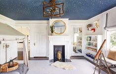 a living room with white walls and blue ceilinging is decorated in gold stars on the ceiling