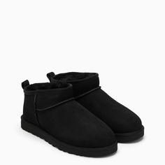 Black suede low boot by UGG, featuring regenerated wool lining, reversed sheepskin upper, round toe and Treadlite sole by UGG.Upper: 100% Shearling / Lining: 80% Regenerated wool - 20% Lyocell / Embroidery: 100% Polyester / Rubber sole Low Uggs, Uggs Ultra Mini, Uggs Mini, Ugg Shoes Women, Ugg Ankle Boots, Ugg Ultra Mini, Black Ugg Boots, Ugg Classic Ultra Mini, Ugg Mini