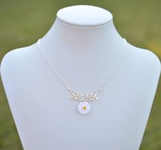 "2018 COLLECTION, ATHENA. A nature inspired necklace featuring white Gerbera with Yellow Center dangled on metal branch. Perfect for bridesmaid gift or flower girl jewelry. Detail : - Hand sculpted flower made of Polymer Clay . Size approx: 17mm. - Silver plated over brass branch as pictured. - Cream Swarovski Pearls - Silver Plated over brass chain as pictured, gold plated, rose gold available. - Entire length 16\" + 2 extenders. - Made to order in 3-4 business days. If you need earlier shippin White Flower Pendant Jewelry With Adjustable Chain, White Adjustable Flower Charm Necklace, White Sterling Silver Charm Necklace With Flower, White Adjustable Charm Necklace With Flower Charm, White Sterling Silver Charm Necklaces With Flower Charm, White Jewelry With Adjustable Chain For Bridesmaid Gift, Delicate White Flower Charm Necklaces, Delicate White Flower Charm Necklace, White Sterling Silver Charm Necklace With Flower Pendant