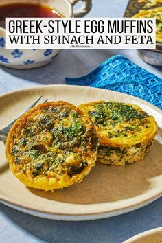 two egg muffins with spinach and feta on a plate next to a cup of tea