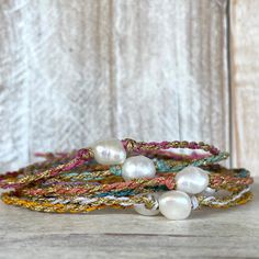 With a kiss of golden sun, this beautiful Beso del Oro bracelet is sure to add a touch of sparkle to your life! We weave one beautifully imperfect freshwater baroque pearl with gold and your choice of colorful waxed cord together to create this casual yet stylish piece. The closure is a simple tie on slide knot for easy on and off and is so soft and comfortable you'll forget you're wearing it and makes a great sparkly addition to any stacker ensemble! This bracelet/anklet is completely waterproo Gold Friendship Bracelets With Sliding Knot For Summer, Gold Beaded Bracelets With Sliding Knot For Summer, Gold Adjustable Beaded Bracelets For Summer, Gold Bracelets With Sliding Knot For Summer, Gold Sliding Knot Jewelry For Vacation, Gold Bracelet With Sliding Knot For Vacation, Handmade Gold Braided Bracelet For Vacation, Summer Gold Braided Bracelet With Sliding Knot, Gold Bracelet With Pearl Charm For Beach