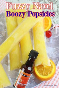 a bottle of boozy popsicles next to sliced oranges and pineapple slices