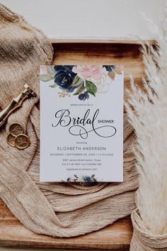 an elegant floral bridal shower card on top of a wooden tray with some fur