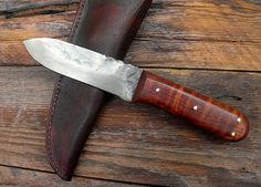 a knife is sitting on top of a leather sheath