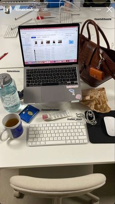 an open laptop computer sitting on top of a white desk