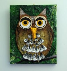 an owl is sitting on a tree branch with eyes wide open and yellow beaks