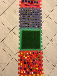 the floor is made out of legos and has many different colored dots on it