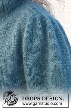 the back of a woman's blue sweater, with her hair in a ponytail