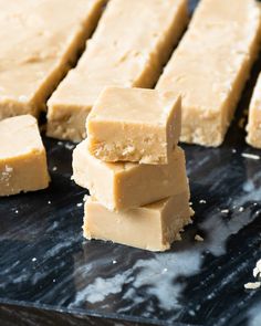 several pieces of peanut butter fudge sitting on top of a black counter next to each other