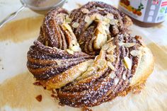 a cinnamon roll sitting on top of a wooden cutting board