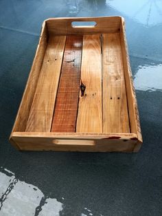 a wooden tray sitting on top of a wet floor