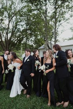 a group of people standing next to each other on top of a lush green field