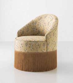 an upholstered chair with a wooden base and flower print fabric on the back