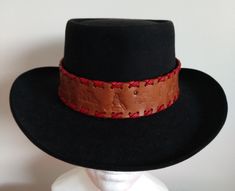 Leather handmade hat band, color antique brown band with red leather edging,and black ties.Indian art.Length "22 inches/width"1 3/4 inches.Fits any cowboy, fedora,and straw hats.Stand out be unique one of a kind.🤜🤛 Vintage Handmade Black Hat Bands, Vintage Black Handmade Hat Bands, Handmade Vintage Black Hat Bands, Red Adjustable Hat For Western-themed Events, Red Fedora With Flat Brim For Western-themed Events, Red Western-style Fedora For Western-themed Events, Vintage Red Adjustable Top Hat, Red Flat Brim Fedora For Western-themed Events, Red Vintage Adjustable Top Hat