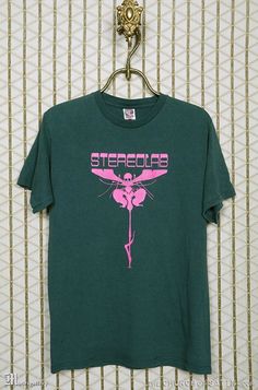 "(BIG NEWS➔ \"SHIRT\" is my newest vintage horror & band tee store, it's at my personal site: www.CTMadrigal.com, via the \"SHIRT\" link in the site's menu. You can join the mailing list for new arrivals too.) STEREOLAB t-shirt. Vintage and rare, soft, faded green, short sleeve T-shirt. Male or unisex style. If there is no photo posted of the back of the T-shirt it means the back is unprinted. The size, if shown on label, may not represent modern sizing, please go by measurements to ensure best Green Grunge T-shirt With Screen Print, 90s Style Green Screen Print Top, Vintage Green Streetwear Shirt, Vintage Green Shirt For Streetwear, Vintage Green Shirt With Screen Print, Vintage Green Short Sleeve T-shirt, Grunge Green T-shirt With Graphic Print, Green Vintage Short Sleeve T-shirt, 90s Style Green Shirt For Streetwear