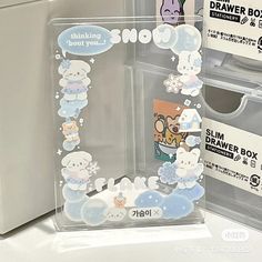 two clear boxes with cartoon stickers on them