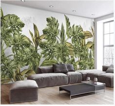 a living room with couches and large wall mural