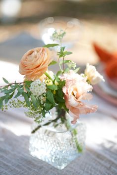 an arrangement of flowers in a vase on a table