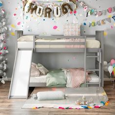 a bunk bed with balloons and confetti on the wall