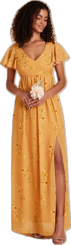 a woman wearing a yellow dress with flowers on it