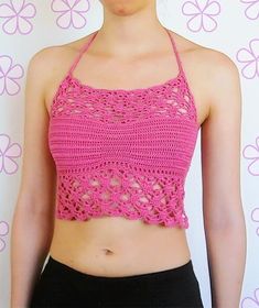 a woman wearing a pink crochet crop top