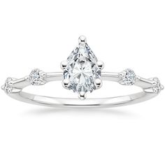 a white gold engagement ring with a pear shaped diamond in the center and three diamonds on each side