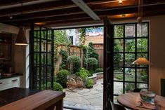 an open patio door leading to a small garden