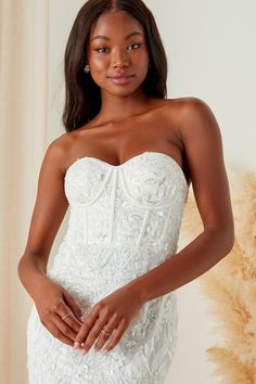 The Lulus Profound Romance White Sequin Embroidered Bustier Maxi Dress is ready to make all of your big day dreams come true! This stunning dress features an array of dazzling details such as gleaming sequins (of varying shapes and sizes), shiny beads, and intricate floral embroidery throughout as it shapes a sweetheart neckline and a strapless, bustier-inspired bodice with hidden no-slip strips, padded cups, and supportive boning. The fitted waist tops a figure-flaunting, mermaid-style maxi ski Gala Wedding Dress With Sweetheart Neckline And Fitted Bodice, Sweetheart Neckline Wedding Dress With Lace Bodice For Banquet, Sweetheart Neckline Wedding Dress With Lace Bodice, Elegant Embellished Corset Dress For Debutante Ball, Fitted Lace Bodice For Debutante Ball, Lace Wedding Dress With Sweetheart Neckline For Banquet, Sleeveless Corset Dress With Sheer Bodice For Wedding, Banquet Dresses With Intricate Embroidery And Fitted Bodice, Intricate Embroidery Fitted Bodice Dress For Banquet