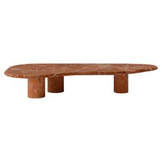 an oval marble table with two legs on each side and one end in the middle