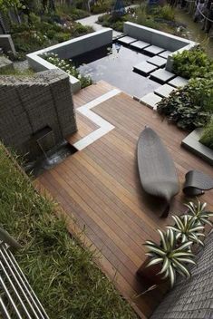 a wooden deck with benches and plants on it