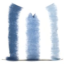 a blue and white pillow on a white background