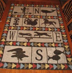 a quilted table runner with animals and letters on it