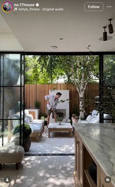 an outdoor living room with sliding glass doors