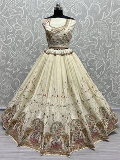 Introducing the glamorous off-white thread work georgette designer lehenga choli! This exquisite ensemble is crafted from high-quality georgette material in a stunning off-white color. With its intricate embroidered work, fancy dori work, multi-thread work, sequin work, zircon diamond work, and zari work, this lehenga exudes elegance and sophistication.
The set includes a similar color georgette material choli that is adorned with fancy embroidered work, dori work, multi-thread work, and diamond Luxury Semi-stitched Off White Choli, Cream Georgette Choli With Zari Work, Cream Zari Work Georgette Choli, Embroidered Off White Georgette Lehenga, Semi-stitched White Georgette Choli, Lehenga Choli Designs, Georgette Material, White Lehenga, Designer Lehenga Choli