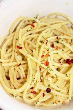 a white bowl filled with pasta and sauce