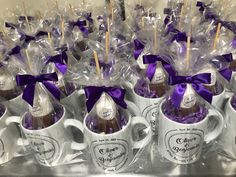 coffee mugs filled with candy and wrapped in purple ribbon