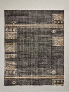 an area rug with black and beige designs