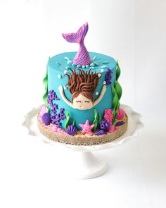 there is a cake with a mermaid on it