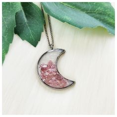 "Handmade strawberry quartz and rose quartz crescent moon bezel resin pendant necklace. Pendant Size: See Pics For Measurements & Size Scale Comparisons Chain Length: My pendant necklaces are made with a standard \"Princess\" length 18\" chain; I also offer custom length options. Choose your custom length by using the \"Necklace length\" drop-down menu located just above the add to cart button* (*length reference chart shown in pics) Colors: Pastel Pink, Dark Magenta Pink, Pearl White, Gunmetal Silver Gray Materials: Pendant: Strawberry Quartz Chips, Rose Quartz Chips, Resin, & Silvertone Stainless Steel Chain: Gunmetal Silvertone Stainless Steel (due to a variety of monitor/screen settings, IRL color may vary slightly, pics taken in natural light)" Half Moon Metal Necklace For Gifts, Half Moon Metal Necklace For Gift, Pink Bohemian Resin Jewelry, Bohemian Pink Resin Jewelry, Pink Moon Charm Jewelry, Pink Round Moon Charm Jewelry, Half Moon Metal Jewelry Gift, Pink Moon-shaped Jewelry With Moon Charm, Pink Moon-shaped Jewelry Gift