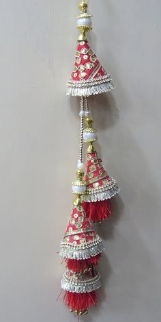 Red And Golden Fabric Gota Patti and Pearl Beaded Traditional Indian Bridal Lehenga Tassels | Ethnic Sewing Tassel Latkan For Indian Saree Handmade Hanging/tassels Material:Silk, Thread, Motifs, Gota Patti Package Contents: 4 Key Features: Embroidery art work This is good match with both Indian Bridal Lehenga outfits and are superb for wedding and festive parties. This would be best complement to your designer saree, lenhga or any other kind of dress. This is the combination of traditional and m Luxury Traditional Danglers With Latkans, Luxury Red Jhumkas With Latkans, Traditional White Sets With Tassels, White Traditional Sets With Tassels, White Sets With Tassels For Festivals, Festive White Sets With Latkans, Eid Wedding Sharara With Tassels, Festive Sharara With Tassels And Traditional Drape, Festive Traditional Drape Sharara With Tassels